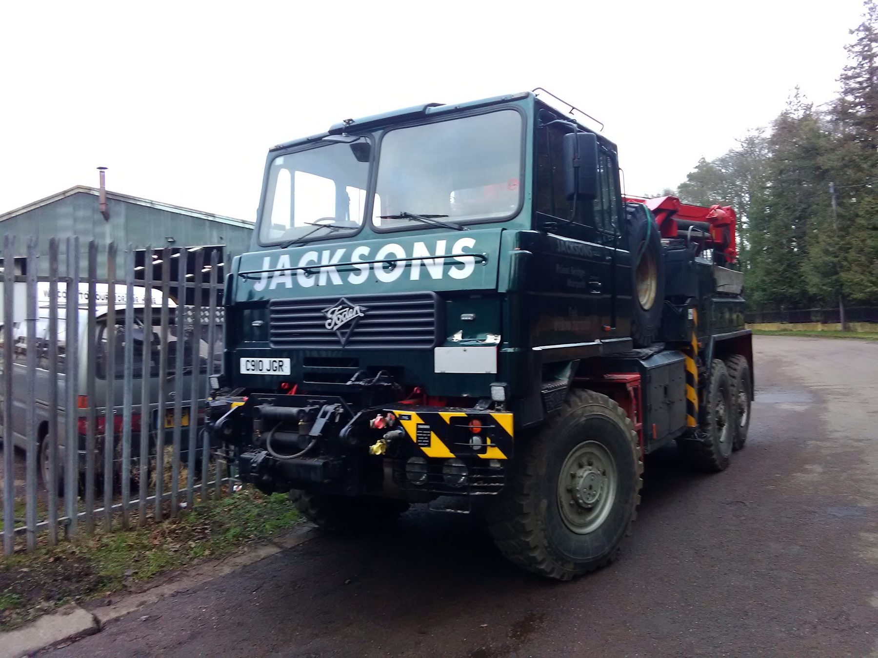 Green JACKSONS heavy recovery wrecker in the yard